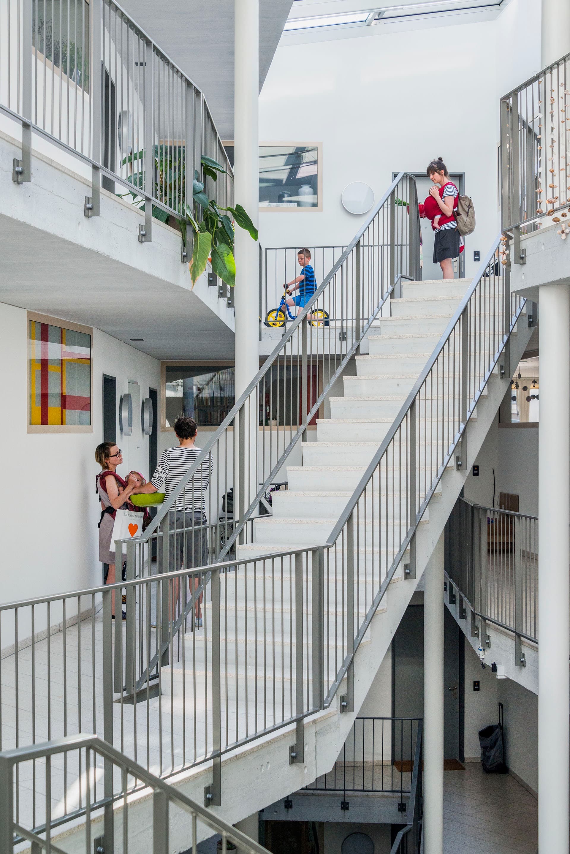 The social mix across Mehr Als Wohnen is immediately evident, and builds a genuine, and diverse, community of residents. Here, residents are shown gathering in the stairwell of Duplex Architekten’s House M.