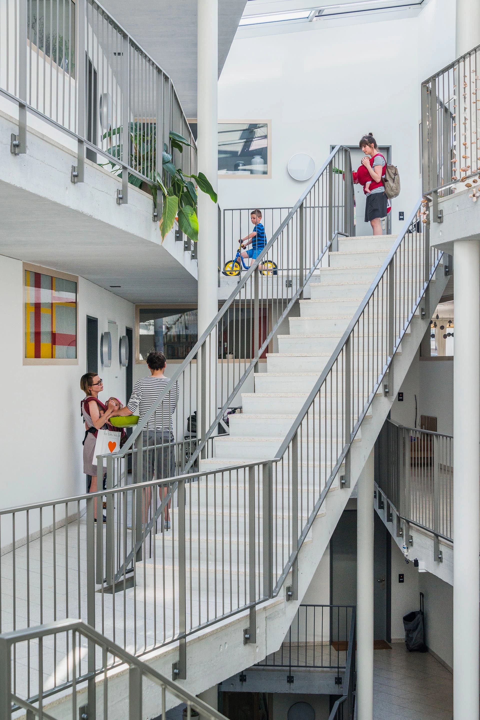 The social mix across Mehr Als Wohnen is immediately evident, and builds a genuine, and diverse, community of residents. Here, residents are shown gathering in the stairwell of Duplex Architekten’s House M.