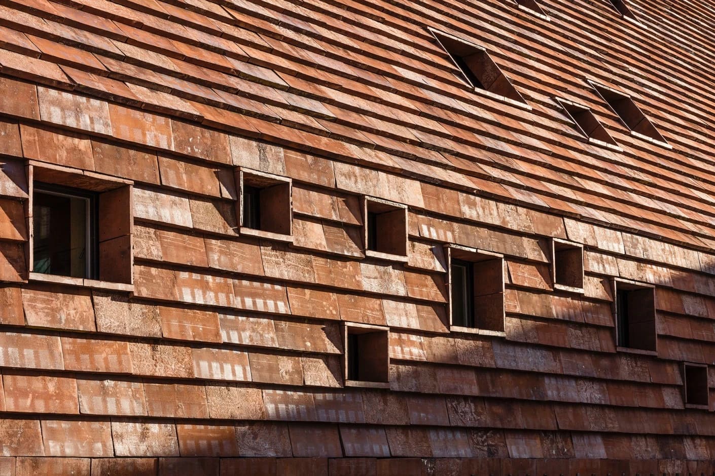 Rustic tiles punctured by small window.